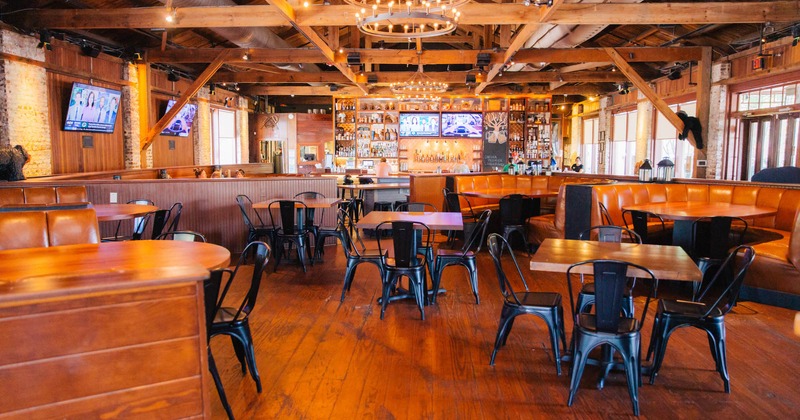 Interior, seating area, large seating booths, wooden beams, bar in the back