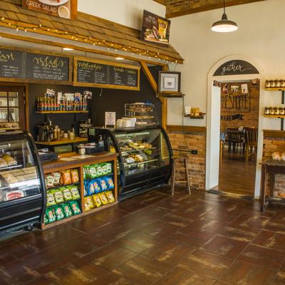 Interior featuring wooden accents, display cases for baked goods, and snack shelving.