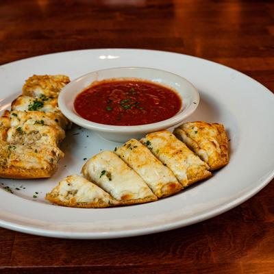 Sliced pastry with cheese, red sauce on the side