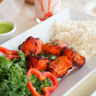 Chicken kebab served with rice and kale salad.