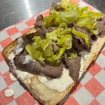Italian beef sandwich, with peppers and cheese.