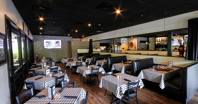 Interior, tables with checkered table cloths in dining area