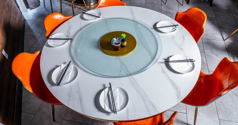 Circular dining table with orange chairs
