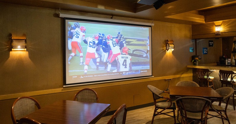 Interior, tables and chairs, projector screen on the wall
