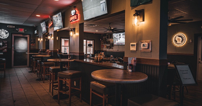 Interior, seating area with a rounded bar tables with chairs