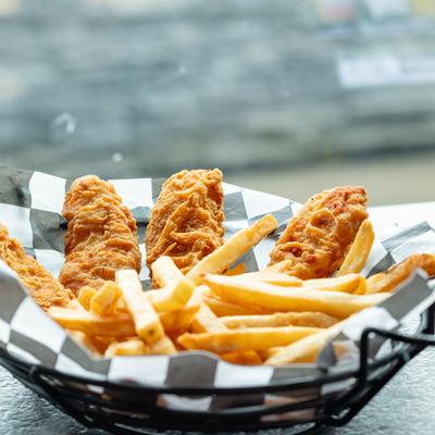 A basket of Chicken Tenders and French fries.
