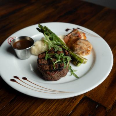 Surf and Turf dish with filet mignon, shrimp, mashed potatoes and asparagus.