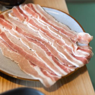 Sliced bacon on a plate, closeup.