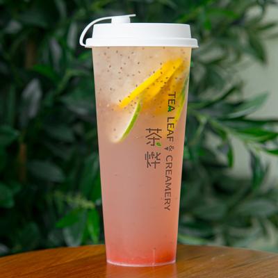 Strawberry Fruit Tea on a table, with a leafy green background.
