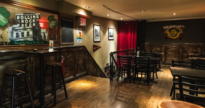 Interior, upstairs dining area, stairs with railing, high and regular seating tables