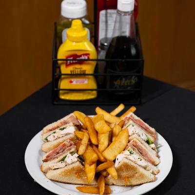 Chicken Club Sandwich served with French Fries..