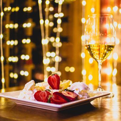 Strawberry Cheesecake and glass of wine, side view