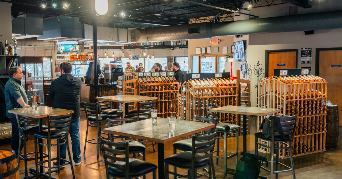 Tasting room, tables and seating, racks with drinks