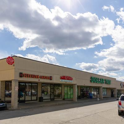 Strip mall exterior showing restaurant storefront signage.
