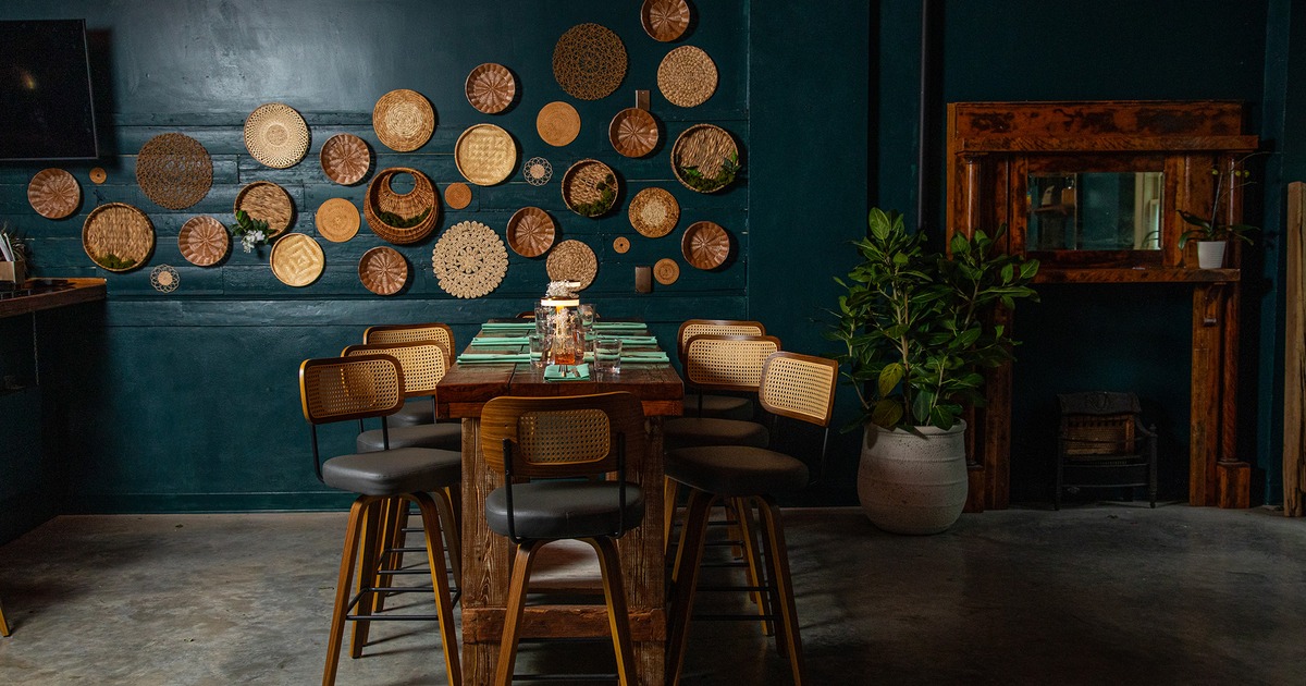 Interior space, high table set for eight guests, wall decoration