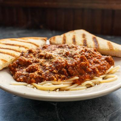 Spaghetti with homemade tomato and meat sauce, served with toast.
