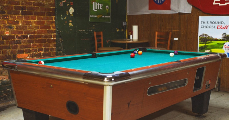 Interior, pool table and high chairs in corner