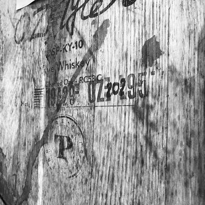 wooden half barrel keg with some unreadable writing.