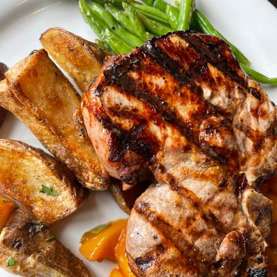 Grilled pork chop, with roasted potatoes, and green beans
