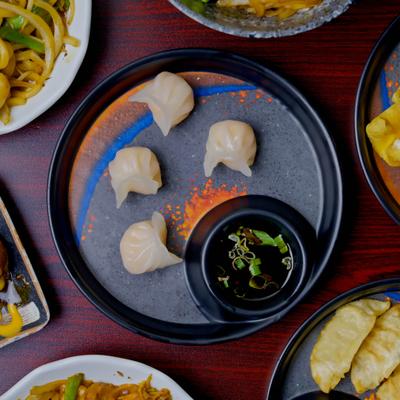 Steamed dumplings with dipping sauce.