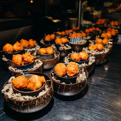 Bowls of crispy fried skewered balls.