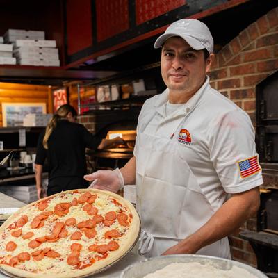 Chef making a pizza.