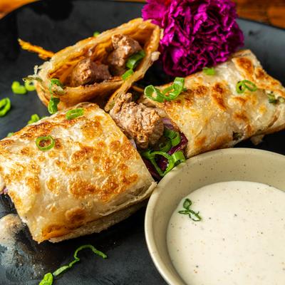 Beef Scallion Pancake Wrapped, served with yum yum sauce on the side.