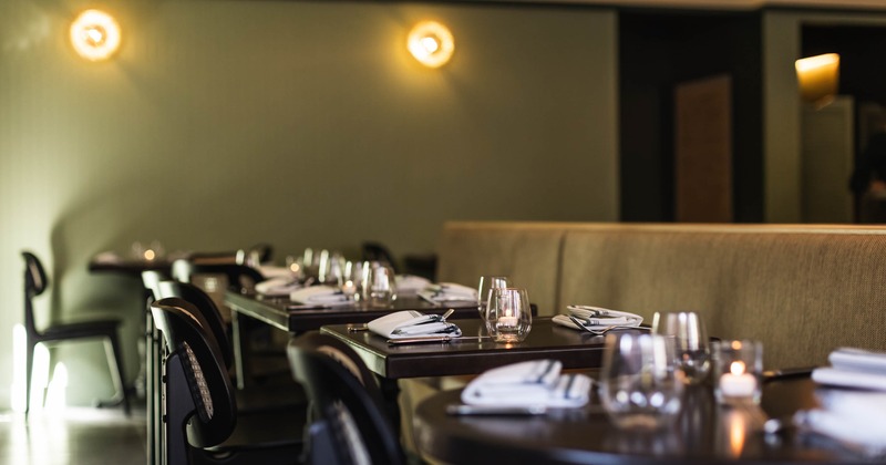Interior, dining area, dining tables for two, ready for guests, candles as a centerpiece