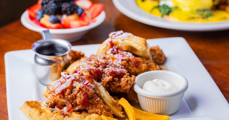 Chicken and waffle topped with syrup