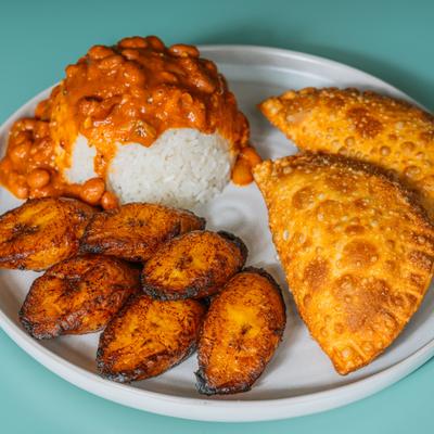 Empanadas with rice, beans, and fried plantains.