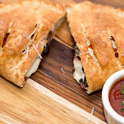 Calzone  with a tomato sauce.