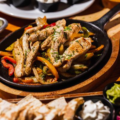 Chicken Fajitas, with mixed peppers, onion, and cilantro.