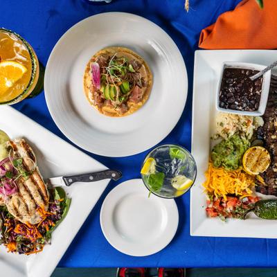 Asortiment of dishes served on the table with drinks, top view.