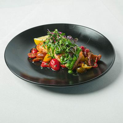 Grilled salmon, with cherry tomatoes, basil sauce, and microgreens.