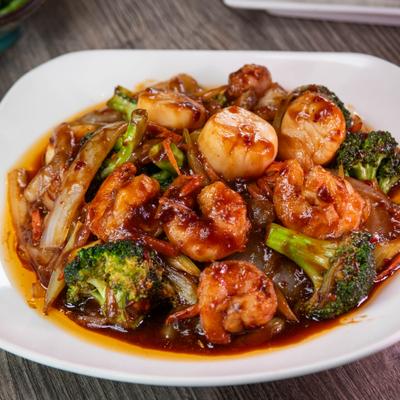 Shrimp and scallops in garlic sauce with vegetables.