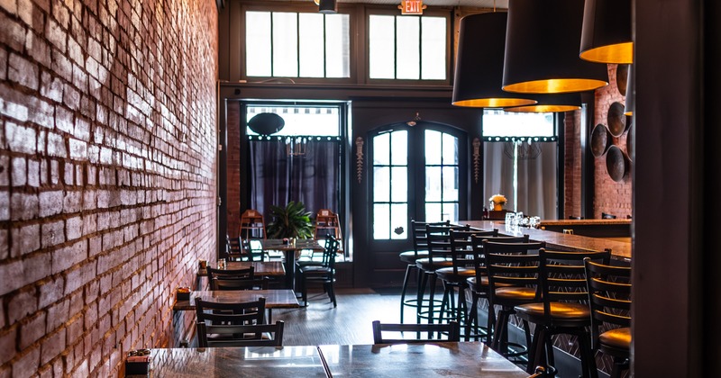 Interior, diner area, tables, chairs, bar on left