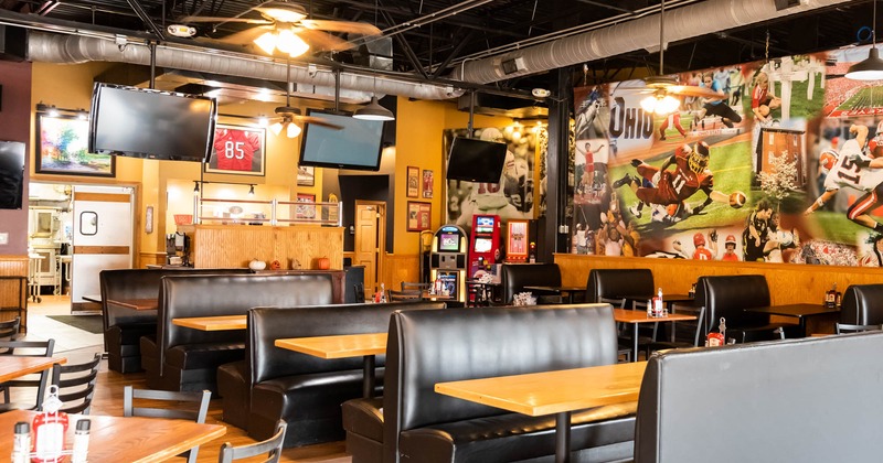 Interior, booths, tables, TV screens, chairs, decorations, lighting