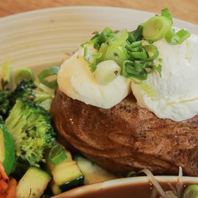 Pot roast, baked potato and veggies, close up