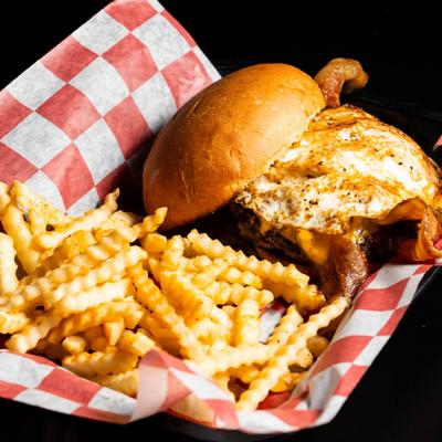 Bacon cheeseburger, with fried egg and fries.
