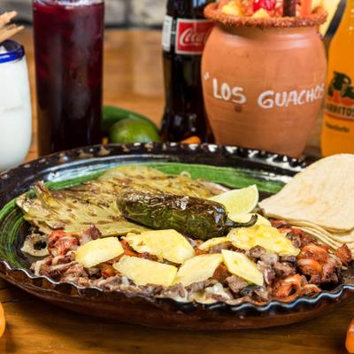 Sliced pork, beef, onions, mushrooms, sliced cactus, melted cheese and roasted jalapeños