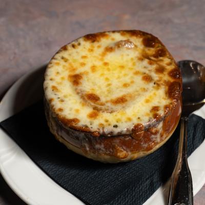 Onion Soup Au Gratin with melted cheese on top.