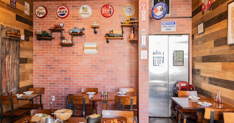 Dining room with tables and meals on them, view towards the kitchen door
