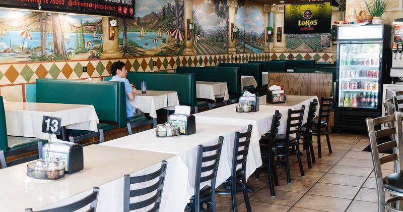 Interior seating area with chairs, tables and double booths