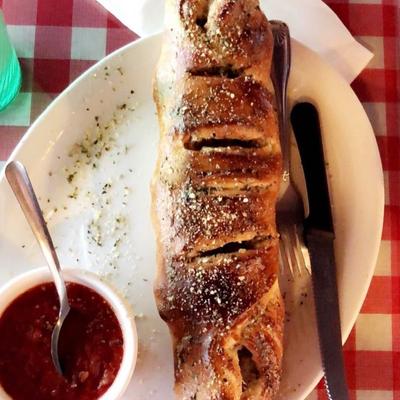 Stromboli with cheese, ricotta and spinach served with marinara sauce on the side.