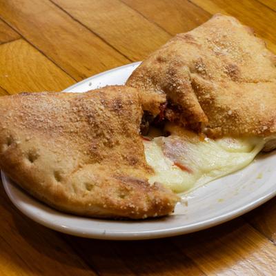 Calzone with melted mozzarella cheese.