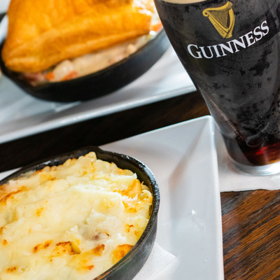 Two dishes and a glass of Guinness