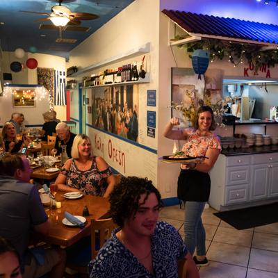 Inside the restaurant, guests dining and staff in action
