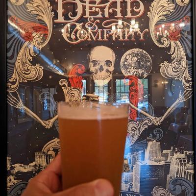 Glass of beer in a hand.