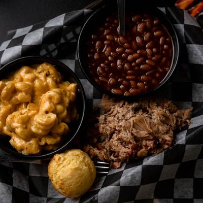 Pulled pork served with corn muffin, BBQ beans, and mac n cheese.