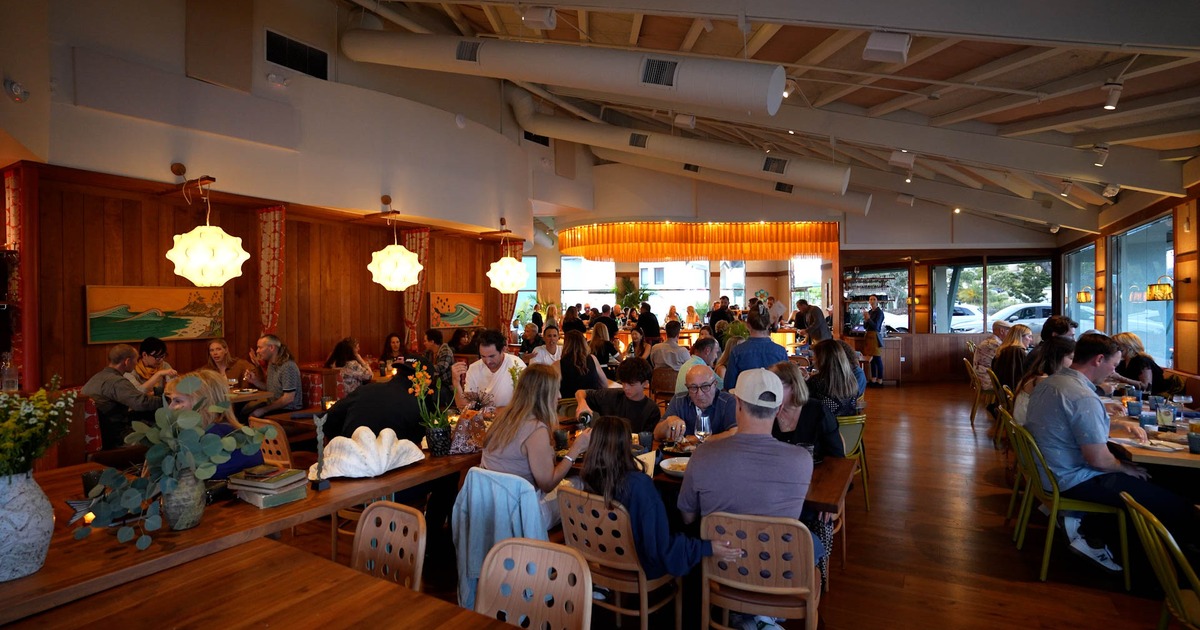 Spacious and cozy interior dining area with set dining tables ready for guests